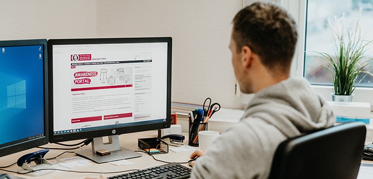 An employee visits the awareness portal on the computer